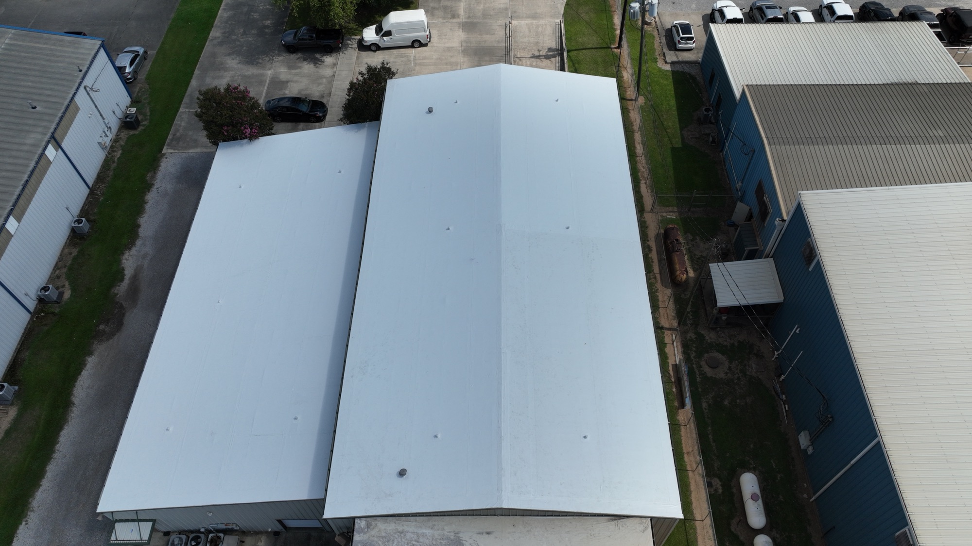 Catholic Diocese warehouse roof replacement in south Louisiana by Bayou Roofing — long-span aerial view of bright white reflective membrane